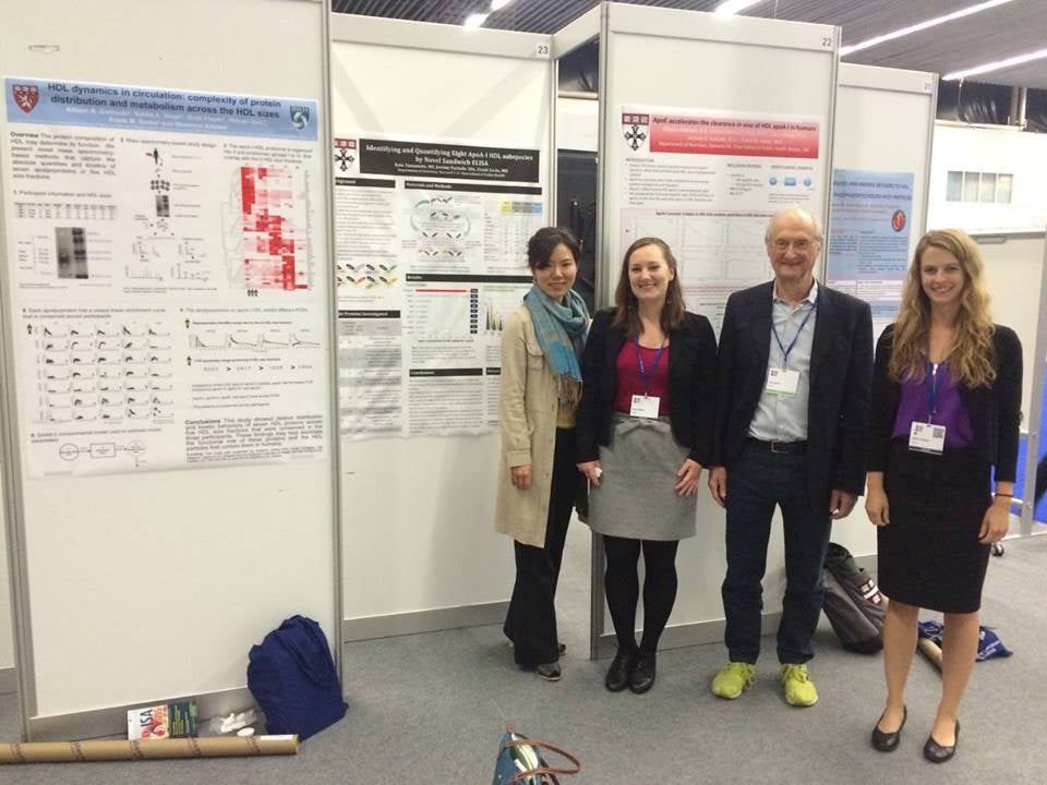 Frank Sacks and three of his PhD students from Harvard School of Public Health stand in front of a poster, presenting their work at the International Symposium on Atherosclerosis in Amsterdam.