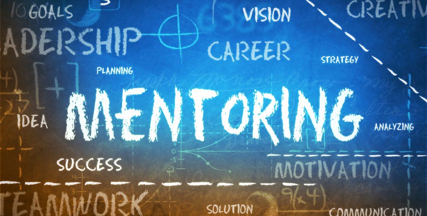Mentoring is written in blue and lit up with various smaller words around it, including the words career, vision, and leadership.