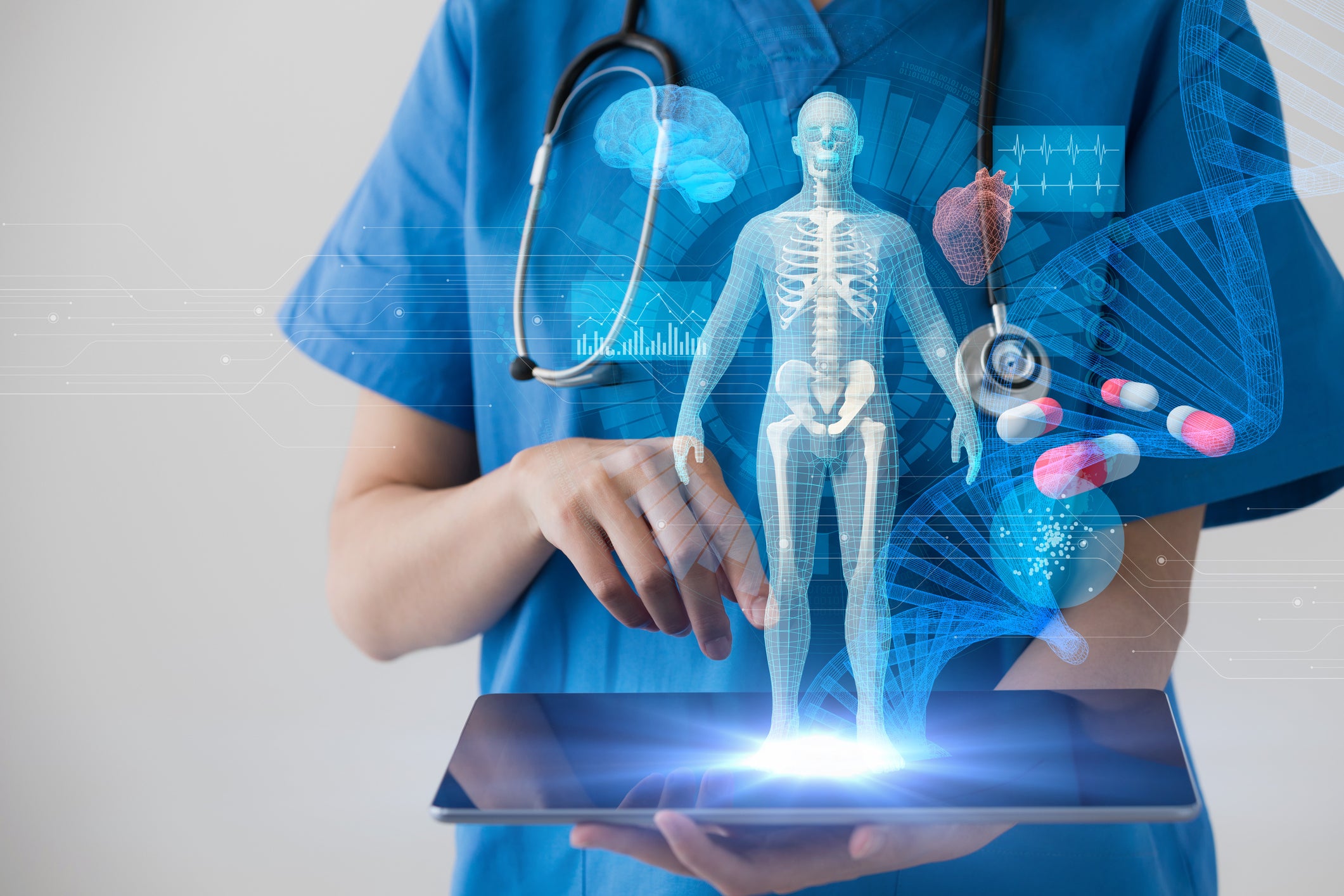 Doctor holding tablet with hologram of a body.