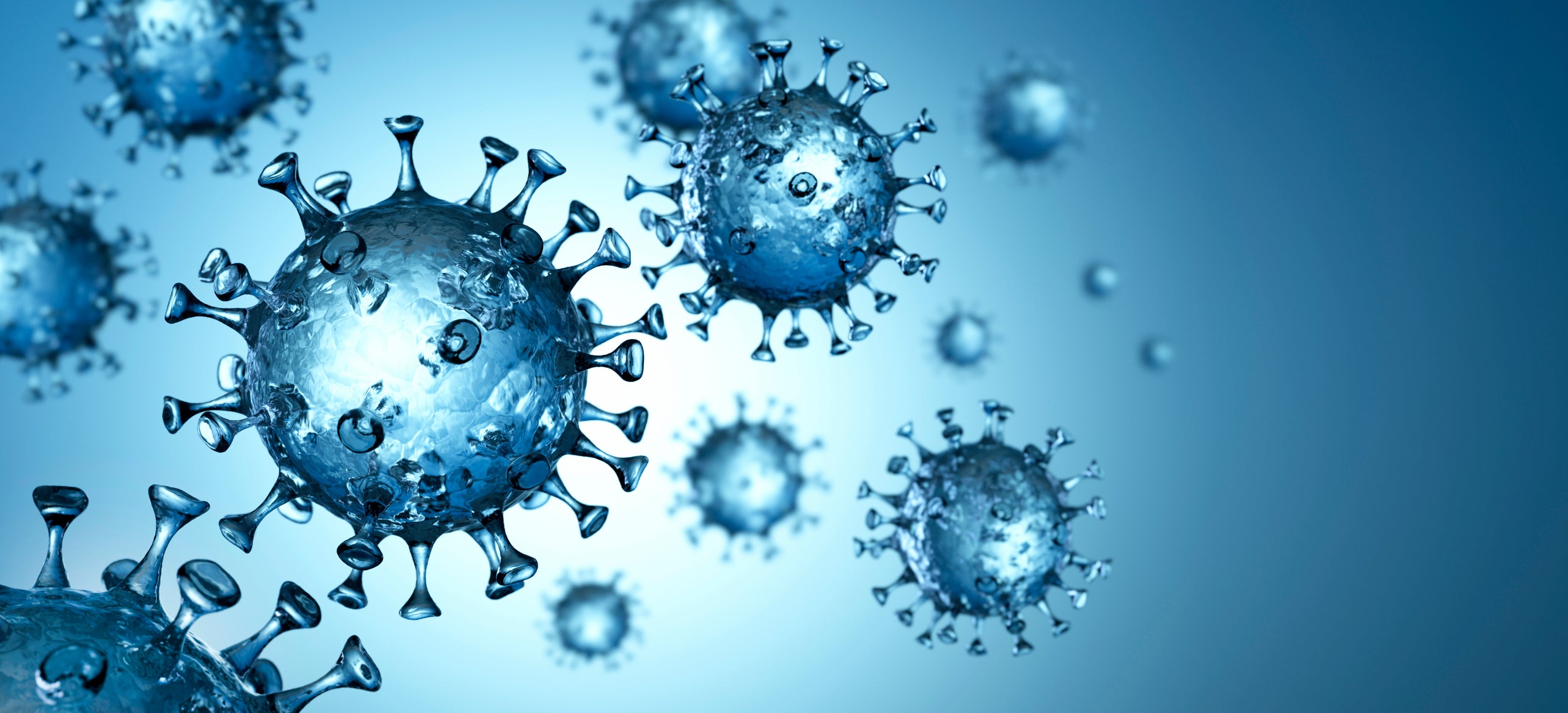 Group of floating coronaviruses with blue background.