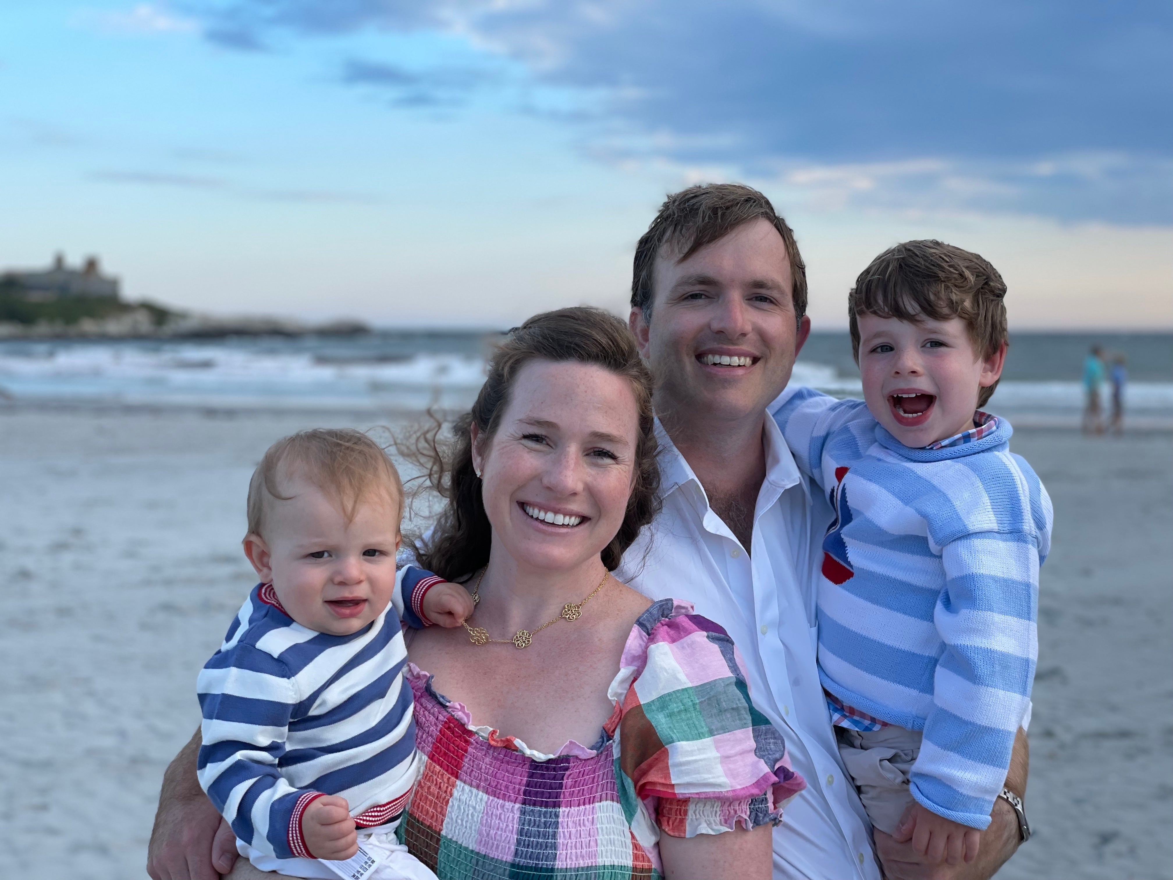 Christina Manice on a beach with her husband and two children.