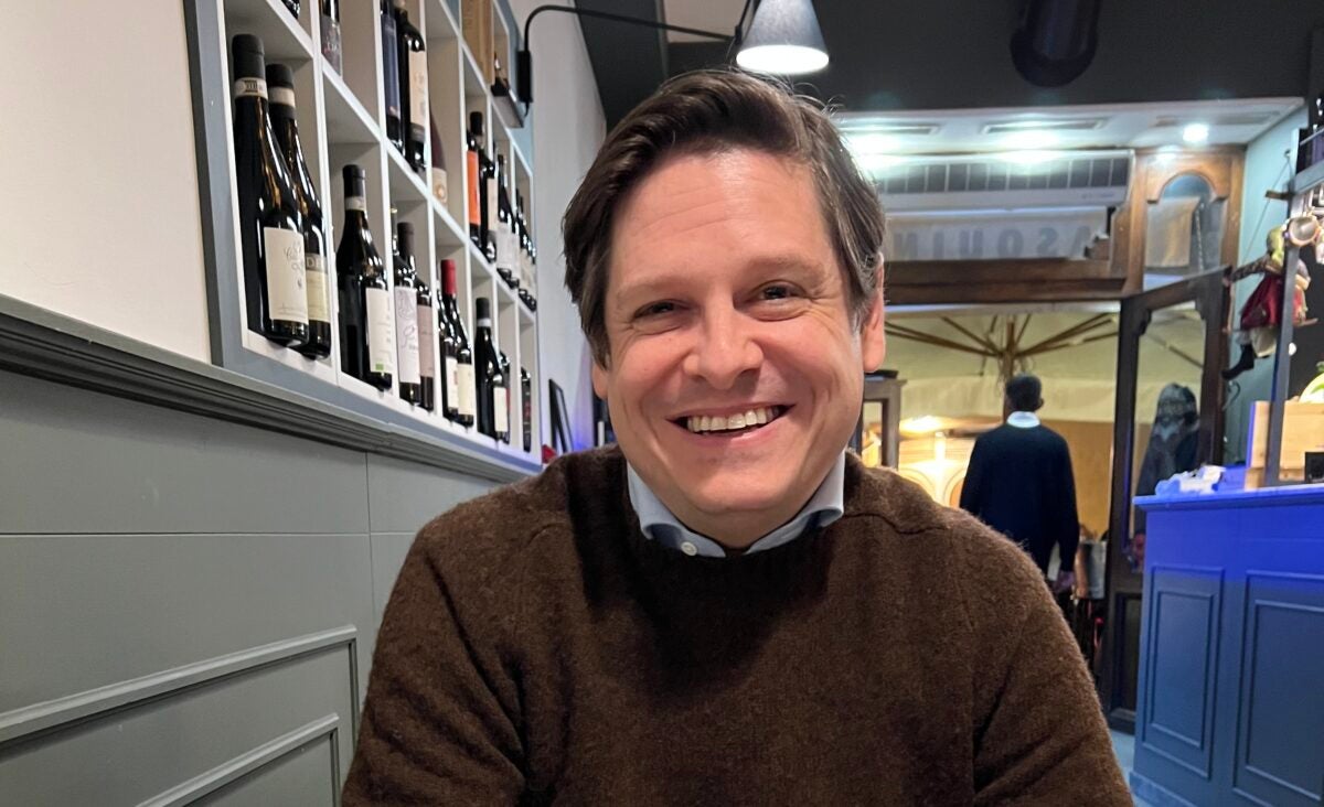 Adam Durbin seated in a restaurant and smiling.