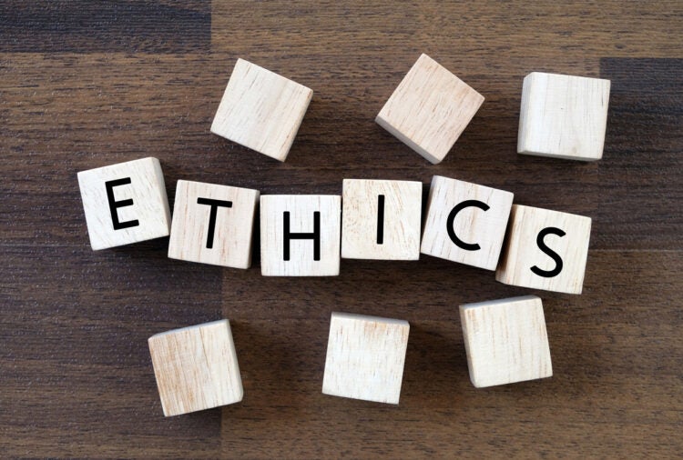 Wooden building blocks that spell out ethics.